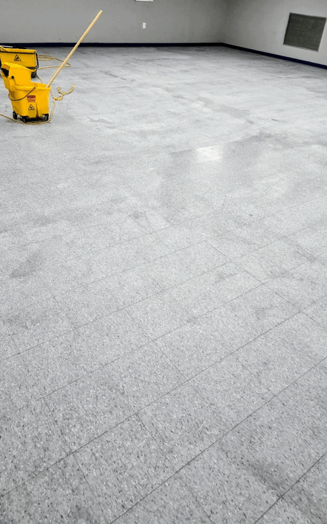 Yellow mop bucket in empty space
